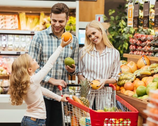 happy-young-family-standing-with-trolley_171337-2386